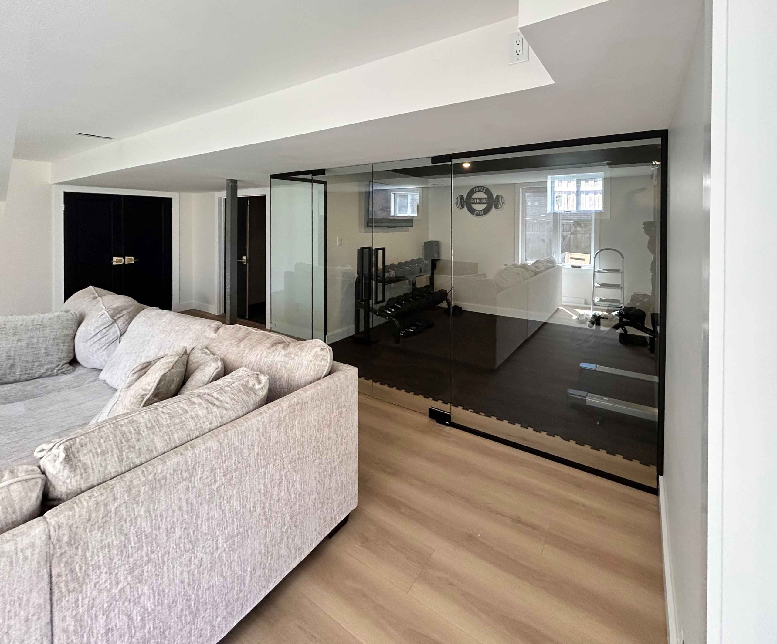 Glass wall and partitions with sliding door for home gym