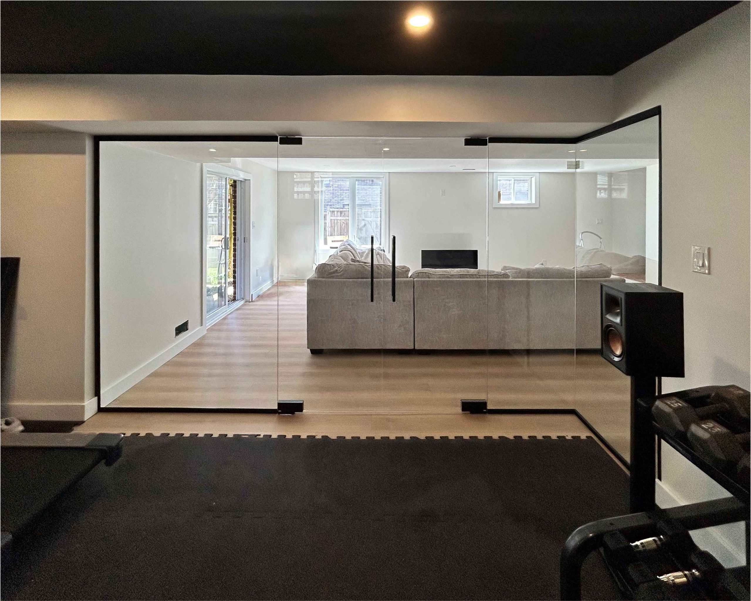 Glass wall and partitions with sliding door for home gym